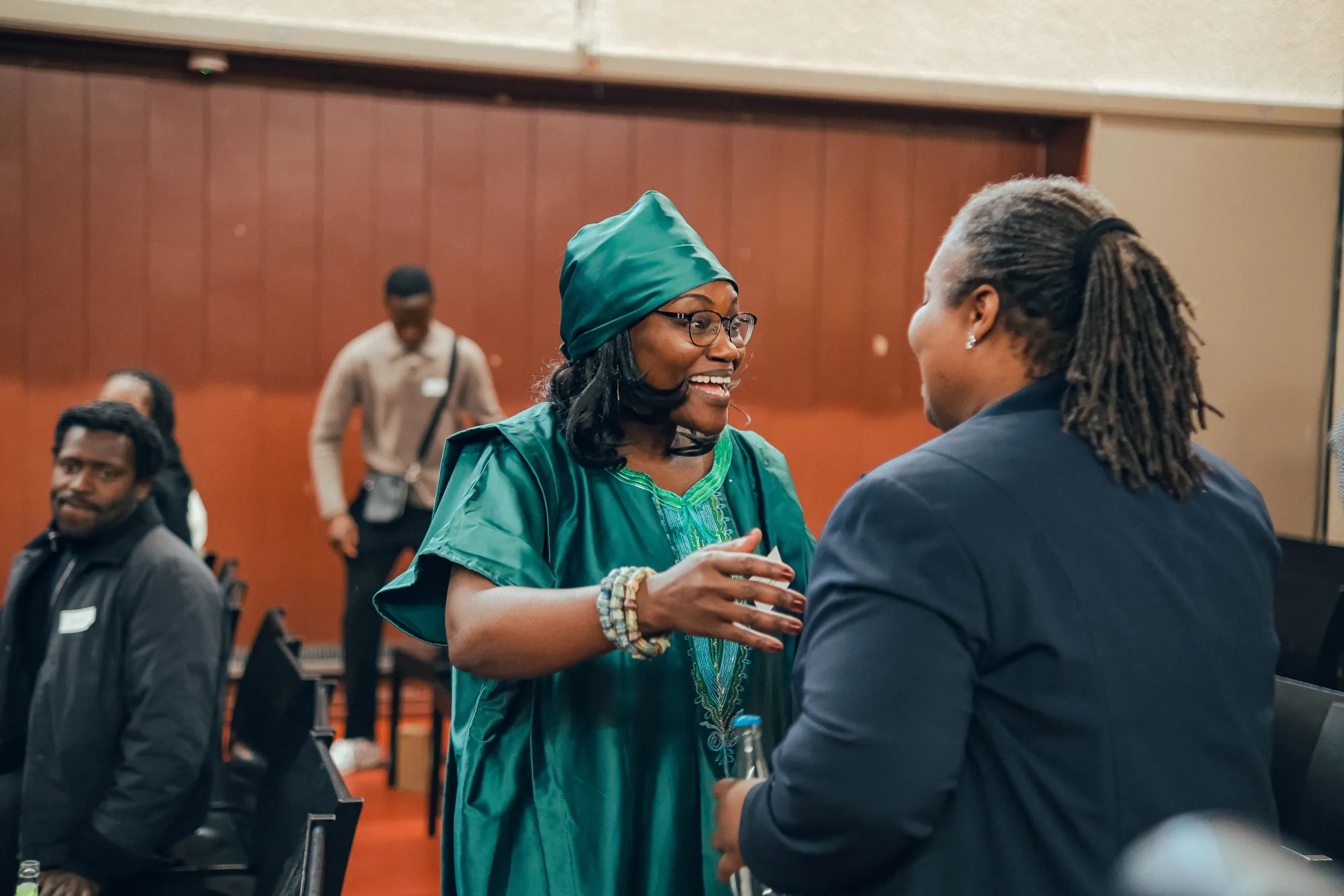 Lizebeth Taylor greeting a member of the community.